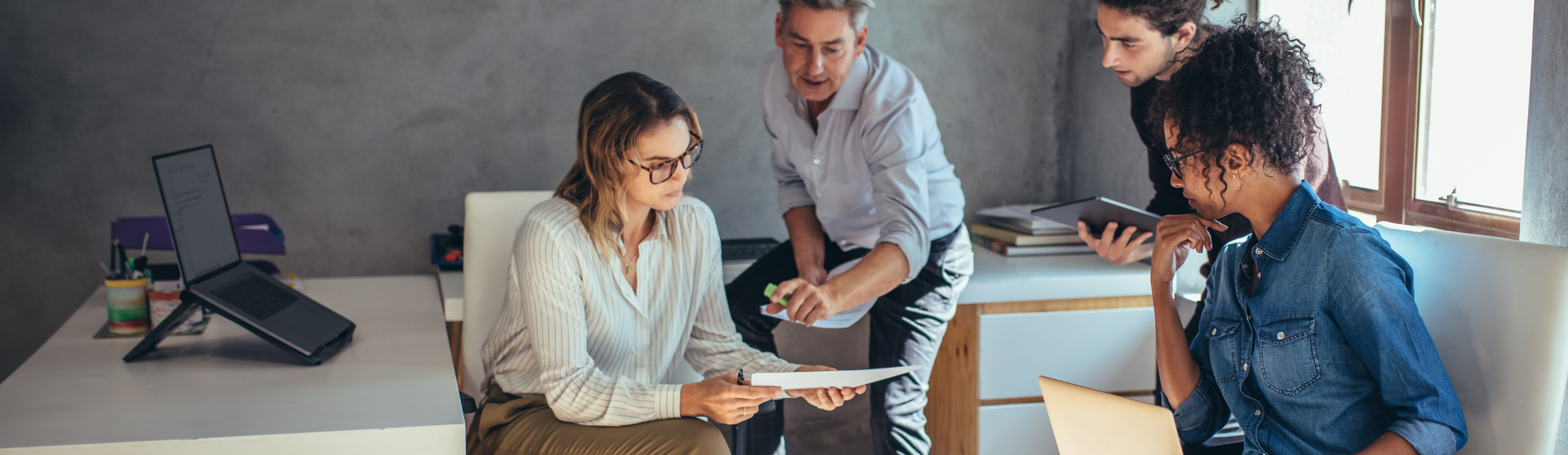 group of co-workers going over financials in an office setting