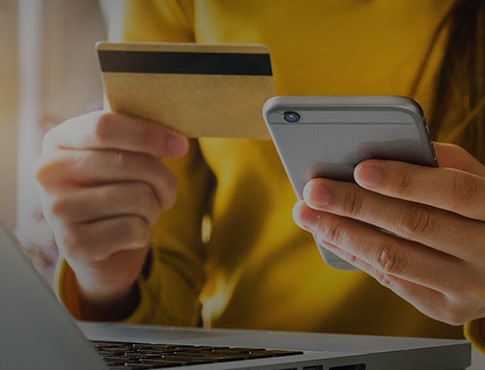 woman holding phone and credit card